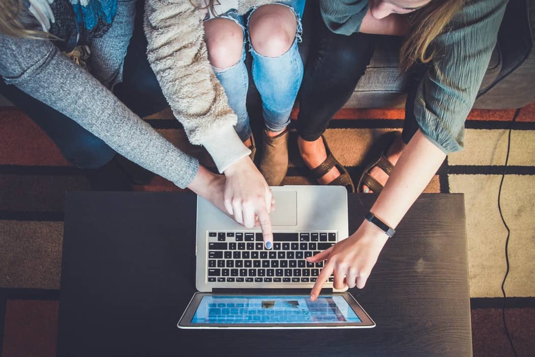 Three girls and MacBook