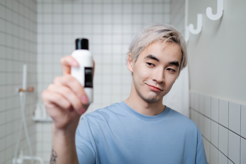 Male influencer showing skincare product