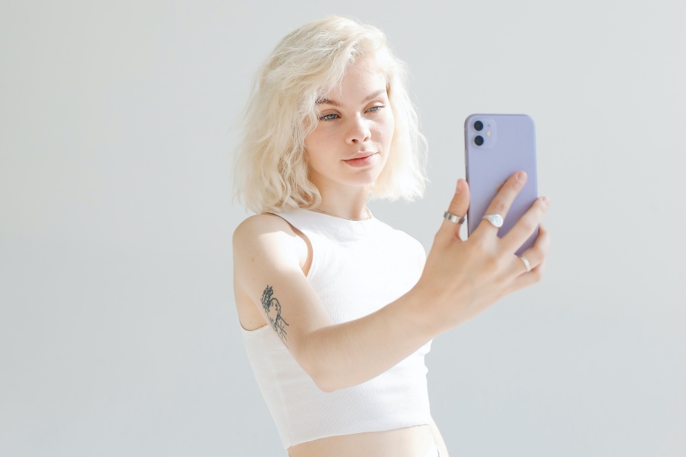 Blonde haired influencer taking selfie