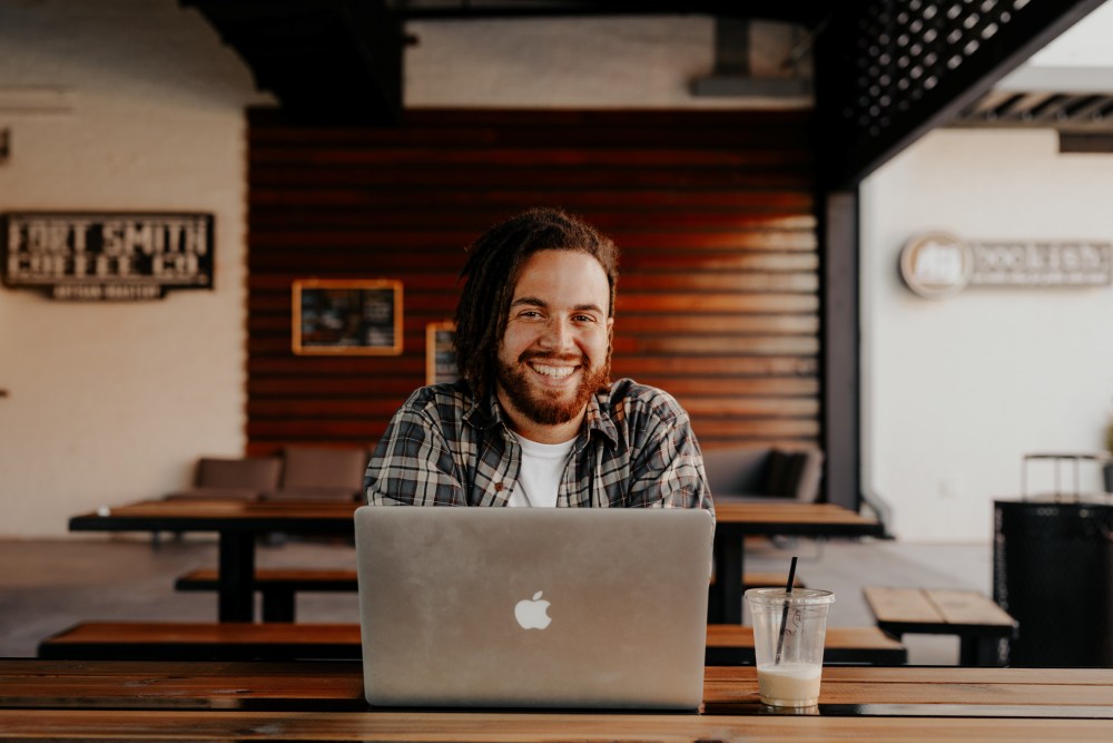 Smiling man working at laptop
