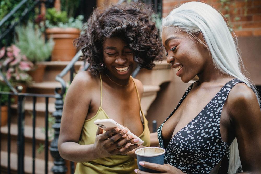 Two woman smiling at phone