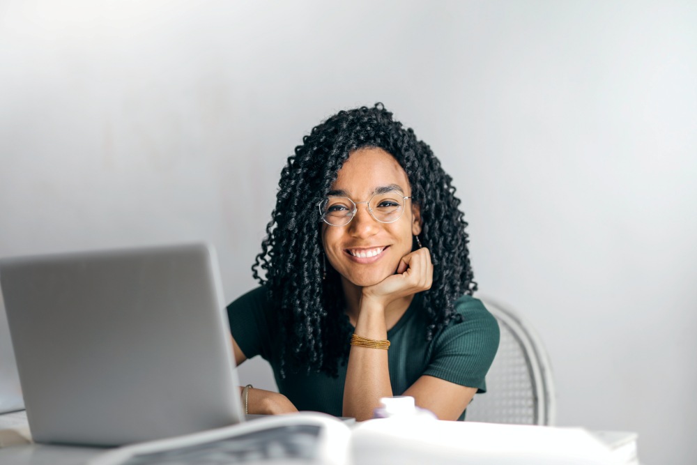 Woman sitting at laptop and smiling